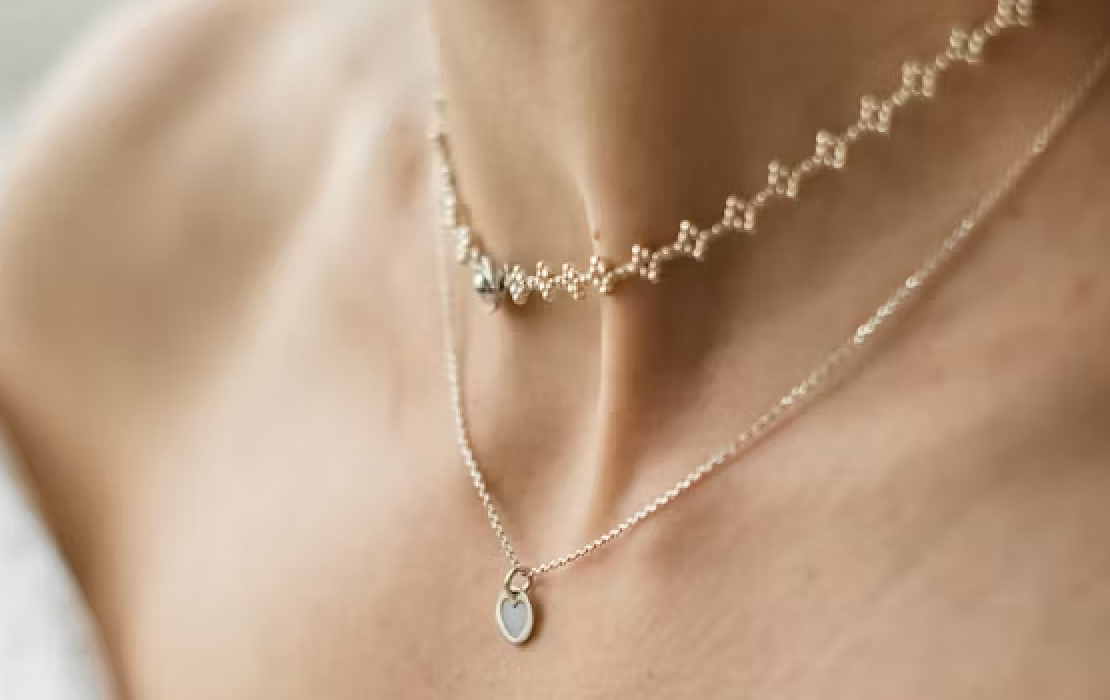 Layered diamond pendant necklaces against skin