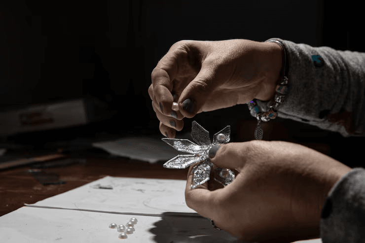 A Diamond Soirée jeweller setting a stone by hand